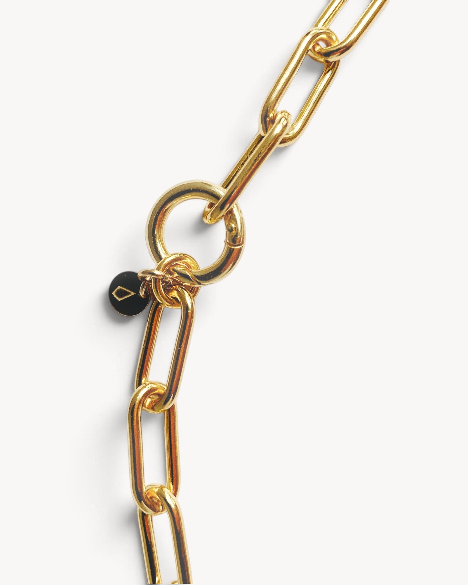 Molokai Quinn gold chain necklace featuring large interlocking links and a small black circular charm detail