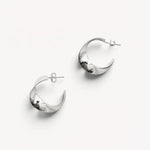 Molokai Zora twisted silver hoop earrings with a polished finish on a clean white background