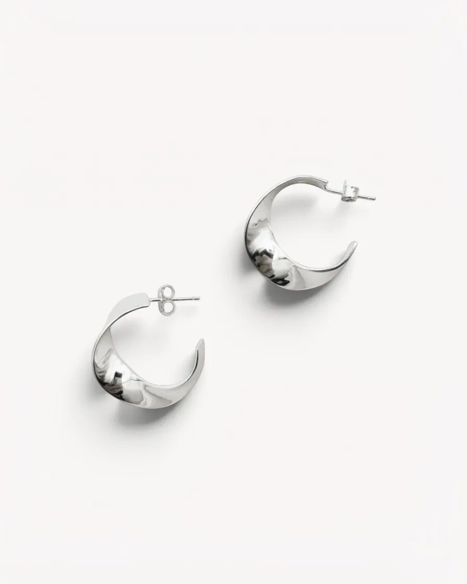 Molokai Zora twisted silver hoop earrings with a polished finish on a clean white background